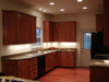 Maple cabinets, Oak floors, Recessed lights, and Under cabinet lighting.